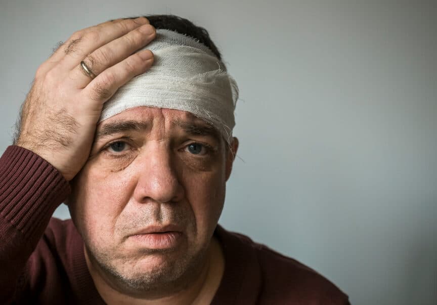 Man with ear pain, head injury. His head is bandaged